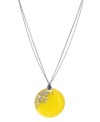 Amp up your look with punch-bright color. Kenneth Cole New York's chic circular pendant is made from yellow resin with sparkling crystal accents. Set in hematite-plated mixed metal. Approximate length: 16 inches + 3-inch extender. Approximate drop: 1-3/4 inches.