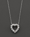 From the Tiny Treasures collection, a diamond heart necklace with signature ruby accent. Designed by Roberto Coin.