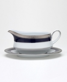 Formal white fine china displays a dramatic combination of scrolling leaves on shimmering platinum and an inner band of intense cobalt blue. Dishwasher safe.