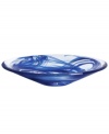 A dramatic accent, the Tempera Blue dish features heavy glass laced with hand-painted swirls of deep blue. Designed by Anna Ehrner for Kosta Boda.