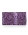 The understated exterior of this sublime Kenneth Cole New York leather flap clutch hides the fully loaded functionality within.