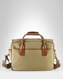 Drawing rustic inspiration from days spent in the great outdoors, a handsome bag is rendered in durable canvas with antiqued brass accents and burnished leather trim for an authentic, timeworn look. Drawing rustic inspiration from days spent in the great outdoors, a handsome bag is rendered in durable canvas with antiqued brass accents and burnished leather trim for an authentic, timeworn look.