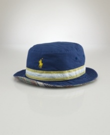 Complete the perfect beachside look with a casual bucket hat, crafted in a reversible silhouette for versatile style. Complete the perfect beachside look with a casual bucket hat, crafted in a reversible silhouette for versatile style.