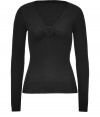 Raise the bar on ladylike luxe with Valentinos undeniably elegant black wool pullover -  Feminine, fitted silhouette tapers gently through waist  - Long sleeves and flattering draped v-neckline with rosette embellishment - Seamlessly transitions from the office to dinner, drinks and events - Pair with pencil skirts, cigarette pants or ankle-cropped trousers and style with ballet flats or classic pumps