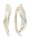 Up your glam factor. Yell'Ora's chic twisted hoop earrings showcase baguette-cut diamonds front and center (1/4 ct. t.w.). Base metal made from a combination of pure gold, sterling silver and palladium. Approximate diameter: 3/4 inch.