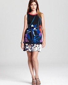 Searing blossoms glow against this sleek T Tahari dress, finished with a contrast hem for modern feminine attitude. Searing blossoms glow against this sleek T Tahari dress, finished with a contrast hem for modern feminine attitude.