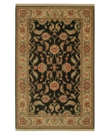 Inspired by the lush tapestries of the 17th-century Mogul dynasty, this classic rug features a scrolling vine design of oversized palmettes and serrated leaves. Green and ivory colors complement the deep shade of a black ground. Woven of premium worsted New Zealand wool. Inspired by the lush tapestries of the 17th-century Mogul dynasty, this classic rug features a scrolling vine design of oversized palmettes and serrated leaves. Green and ivory colors complement the deep shade of a black ground. Woven of premium worsted New Zealand wool.