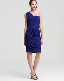 Intricate ruching and artful draping create an impeccably flattering silhouette on this Tadashi Shoji one-shoulder dress. Intricate ruching and artful draping create an impeccably flattering silhouette on this Tadashi Shoji one-shoulder dress.