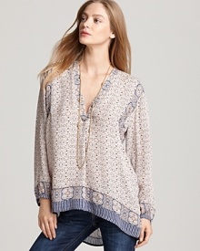 Boast boho chic in this printed Vince tunic, rendered in lightweight silk. Flaunting a deep v neckline with a contrast border print, the flowing look finishes with an asymmetric hem for spring-perfect style. Boast boho chic in this printed Vince tunic, rendered in lightweight silk. Flaunting a deep v neckline with a contrast border print, the flowing look finishes with an asymmetric hem for spring-perfect style.