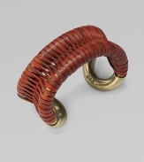 Supple leather wrapped around a cuff frame in a figure-eight design makes for a truly unique piece. LeatherAntique-finished brassDiameter, about 2Slip-on designImported 