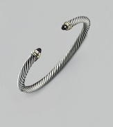 From the Cable Classic Collection. A signature Yurman cable of sterling silver, richly crowned in 14K yellow gold with black onyx end caps. Sterling silver and 14k yellow gold Black onyx Cable, 5mm Diameter, about 2½ Imported