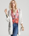 A Free People cardigan layers on the cool with loose, woven texture and a relaxed ease. Perfect for temperate spring days, it's just like grandpa's--but made especially for you.