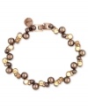 Wrist watching will be the order of the day with this flex bracelet from Givenchy. Crafted from brown gold-tone mixed metal with glass pearls, all eyes will be drawn to this stylish piece. Approximate length: 7-1/4 inches.