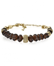 Earthy tones add an elegant touch to this bracelet from Fossil. Crafted from gold-tone stainless steel, the bracelet features beads in shades of smokey topaz for a stylish statement. Adjusts to fit wrist. Approximate length: 7-9 inches.