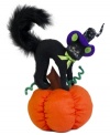 Scared silly, a black cat arches her back and poofs her tail atop the orange pumpkin in this whimsical Annalee figurine. A soon-to-be Halloween favorite.