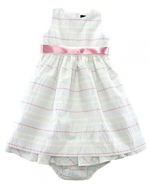A charmingly traditional dress in multi-striped cotton seersucker has a pretty, full skirt with a petticoat and a ribbon sash. A charmingly traditional dress in multi-striped cotton seersucker has a pretty, full skirt with a petticoat and a ribbon sash.
