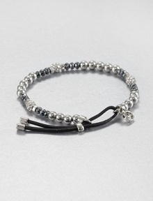 From the Brilliance Collection. A mix of silvery beads includes faceted hematite, smooth stainless steel and rhinestone-crusted spheres, strung on a stretchy strand with a leather slide close.HematiteGlassSilvertone and stainless steelLeatherDiameter, about 2.25Imported From the Brilliance Collection. A mix of silvery beads includes faceted hematite, smooth stainless steel and rhinestone-crusted spheres, strung on a stretchy strand with a leather slide close.HematiteGlassSilvertone and stainless steelLeatherDiameter, about 2.25Imported
