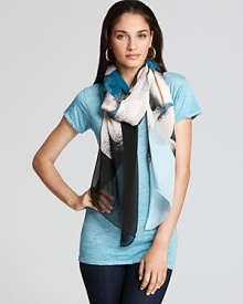 Cream flowers pop against the blue-to-black ombre background of this DIANE von FURSTENBERG scarf.