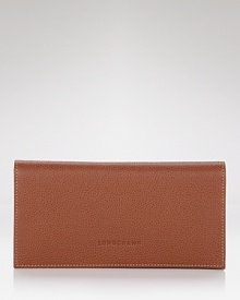 A classic bifold wallet in pebbled leather from Longchamp. A classic bifold wallet in pebbled leather from Longchamp.