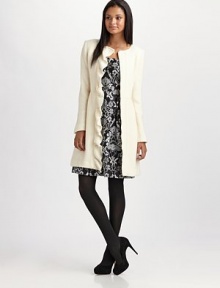 Feminine and tailored in a slim A-line silhouette adorned with a cascading front ruffle.Jewel necklineConcealed front zipperSet-in waistPrincess seamsWelt pocketsAbout 36 from shoulder to hem80% wool/20% nylonDry cleanMade in USA of Italian fabric Feminine and tailored in a slim A-line silhouette adorned with a cascading front ruffle.Jewel necklineConcealed front zipperSet-in waistPrincess seamsWelt pocketsAbout 36 from shoulder to hem80% wool/20% nylonDry cleanMade in USA of Italian fabric