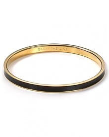 Understated alone and statement making when stacked. kate spade new york's engraved enamel and gold-plated bangle is designed to draw glances.