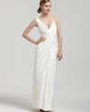 An elegant knot at the bodice of this sweeping gown from Nicole Miller sublimely flatters the frame.