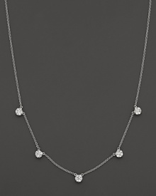 Five diamond cluster stations in a 14K white gold necklace.