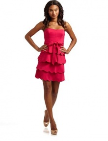 This stunning ponte frock with tiers of scallop ruffles at the skirt and a long sash at the waist, is an easy head-turner.Strapless neckline Seamed bodice with boning Belt loops with waist sash Side zipper Tiers of scalloped ruffles at waist Fully lined About 25 from shoulder to hem 69% rayon/26% nylon/5% spandex Dry clean Imported