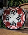 Rwandan women pour heart and soul into the Urukundo fruit bowl, a basket made with and symbolic of love. Hanging on a wall or topping a coffee table, the hand-woven red, black and white pattern makes a bold, meaningful statement.