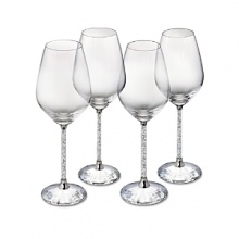 Hundreds of crystals sparkle on the stems of these glittering red wine glasses, while a faceted crystal base reflects light. From Swarovski. Hundreds of crystals sparkle on the stems of these glittering red wine glasses, while a faceted crystal base reflects light. From Swarovski.
