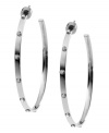 Bring some edge to a timeless look. Michael Kors added stud detail to a classic metal hoop earring. Crafted in silver tone mixed metal. Approximate diameter: 2 inches.