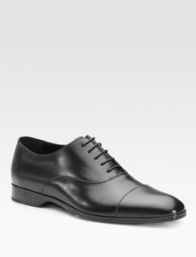 An elegant dress standard features a cap toe and beveled outsole with signature initial detail. Leather lining Padded insole Rubber sole Made in Italy 