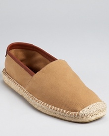 Salvatore Ferragamo bring its signature sophistication to your leisure look. This comfy slip on is crafted in soft cotton, with leather trim and espadrille along the sides and toe. Salvatore Ferragamo bring its signature sophistication to your leisure look. This comfy slip on is crafted in soft cotton, with leather trim and espadrille along the sides and toe.