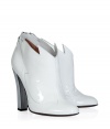 Fashion-forward looks get a futuristic facelift in Laurence Dacades bright white patent leather booties, detailed with a metallic silver heel for that modern-minimalist edge - Rounded toe, decorative topline, stitch detailing, back zip, blocky heel - Pair with contemporary separates and a shimmer of metallic accessories