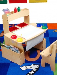Let creativity flourish with a place just for art. This beautifully crafted wood art table has spaces for all their supplies so they can paint and draw endlessly.Roomy work surface with openings for paint jars and slots for paperUnderneath dowel to hold paper rollTop storage shelf and side storage sectionsTwo plastic storage binsSturdy matching bench30W X 20D X 29HWoodMade in USAPlease note: Art supplies not included. Let creativity flourish with a place just for art. This beautifully crafted wood art table has spaces for all their supplies so they can paint and draw endlessly.Roomy work surface with openings for paint jars and slots for paperUnderneath dowel to hold paper rollTop storage shelf and side storage sectionsTwo plastic storage binsSturdy matching bench30W X 20D X 29HWoodMade in USAPlease note: Art supplies not included.