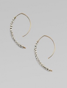 Delicate arcs of 14k gold are set with faceted beads of sterling silver and gold in these elongated, modern hoops with a subtle shimmer.14k yellow gold and sterling silverLength, about 1¼Ear wireMade in USA Delicate arcs of 14k gold are set with faceted beads of sterling silver and gold in these elongated, modern hoops with a subtle shimmer.14k yellow gold and sterling silverLength, about 1¼Ear wireMade in USA