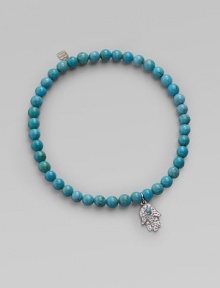 The open hand or hamsa, a traditional symbol of protection in several cultures, is depicted in diamonds set in 14k white gold with a turquoise center, and hangs on a strand of vivid turquoise beads. Diamonds, 0.06 tcw Turquoise 14k white gold Diameter, about 2 Charm length, about ½ Stretch cord Imported The open hand or hamsa, a traditional symbol of protection in several cultures, is depicted in diamonds set in 14k white gold with a turquoise center, and hangs on a strand of vivid turquoise beads. Diamonds, 0.06 tcw Turquoise 14k white gold Diameter, about 2 Charm length, about ½ Stretch cord Imported
