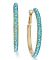 Add a splash of warm color to your look with c.A.K.e. by Ali Khan's turquoise-color glass bead hoop earrings. Crafted in gold tone mixed metal. Approximate diameter: 1-3/4 inches.