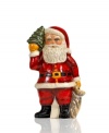 Handcrafted with traditional charm, this Santa Claus figurine wears his classic red suit and holds a bag of presents and a Christmas tree for an extra-festive feel. From Vaillancourt.