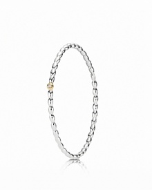 A dazzling diamond set in a 14K gold bezel catches the eye on PANDORA's beaded sterling silver bangle.