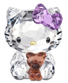 Cuter than ever, Hello Kitty cuddles her favorite teddy bear in this irresistible Swarovski crystal figurine. With printed whiskers and her trademark bow in sparkling violet. Cuter than ever, Hello Kitty cuddles her favorite teddy bear in this irresistible Swarovski crystal figurine. With printed whiskers and her trademark bow in sparkling violet.