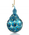 Exquisitely crafted with fine details, this ornament features a pretty peacock sitting upon a ball painted with a peacock feather design. Gold sparkles give it that extra-special shimmer.