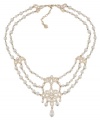 A true dazzler. Embellished with glittering stone accents and glass pearls, you'll strike a chord in this swag frontal necklace from Carolee. Crafted in gold tone mixed metal. Approximate length: 17 inches + 2-inch extender.