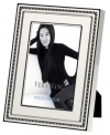 Add new elegance to beautiful memories with Vera Wang's With Love Blanc picture frame. Geometric detail lends metallic shimmer to creamy white enamel in a home accent that invokes modern and deco design.