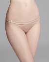 Create a stir with a sultry thong bra featuring lace panels at hips. Style #942109