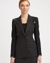 A smattering of sequins is an elegant update on a traditional pinstriped blazer.Notched collar Padded shoulders with solid hued felt trim Long solid hued sleeves Concealed snap closure Pinstriped bodice with sequin insets Front welt pockets About 25 from shoulder to hem Fully lined Pinstriped body: 93% wool/6% cashmere/1% other fiber Solid sleeves: 98% virgin wool/2% other fibers Dry clean Made in Italy