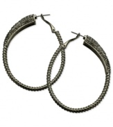 Gray matters on these sparkling clutchless hoops from GUESS. Pave crystals adorn a classic earring silhouette. Crafted in hematite tone mixed metal. Approximate drop: 2-1/4 inches.