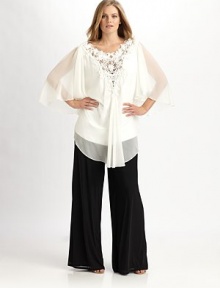 An airy design with pretty flutter sleeves and an incredible beaded-lace neckline. V-neckThree-quarter sleevesBack zipperAbout 33 from shoulder to hemFully linedPolyesterDry cleanImported