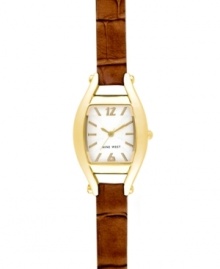 A timely take on a vintage silhouette, by Nine West. Crafted of textured brown leather strap and cushion-shaped gold tone mixed metal case. Silver tone dial with swirling design features gold tone applied stick indices, numerals at twelve and six o'clock, gold tone hour and minute hands, sweeping second hand and logo at six o'clock. Quartz movement. Limited lifetime warranty.