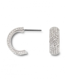 Covered in glittering pave crystals, Swarovski's huggie hoop earrings are a chic, classic look that's versatile enough to take you from the office to a night on the town! Set in silver tone mixed metal. Approximate diameter: 1/2 inch. Covered in glittering pave crystals, Swarovski's huggie hoop earrings are a chic, classic look that's versatile enough to take you from the office to a night on the town! Set in silver tone mixed metal. Approximate diameter: 1/2 inch.